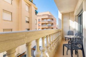a balcony with two chairs and a table at 090 Apartamento Imperial in Torrevieja