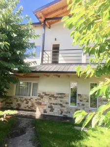 a house with a balcony on top of it at La Calala Aparts in Esquel