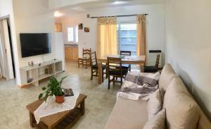 a living room with a couch and a table at La Calala Aparts in Esquel