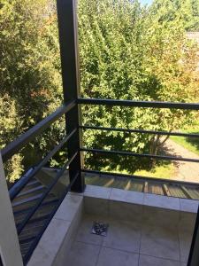 a view of a balcony with a view of trees at La Calala Aparts in Esquel