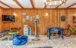 a room with a wooden wall with a bike in it at Lovely Home In Kostrena With Kitchen in Kostrena