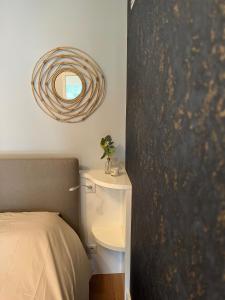 a bedroom with a bed and a mirror on the wall at * Le Hameau de la plage * in Étables-sur-Mer
