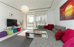 a living room with a couch and a tv at Amazing Home In Zaton With Heated Swimming Pool in Zaton