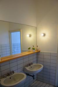a bathroom with two sinks and a mirror at Homelink Firenze - Charlotte in Florence