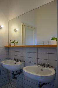 a bathroom with two sinks and a mirror at Homelink Firenze - Charlotte in Florence