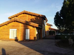 a wooden house with a gambrel roof at Ecolodge Bellevue ALBI in Albi