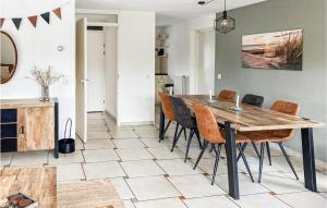 a dining room with a wooden table and chairs at It Soal Waterpark-waterlelie in Workum