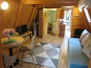 a living room with a couch and a table at Domki ogrzewane Sokół in Władysławowo +30 photos