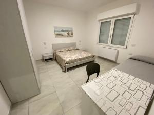 a bedroom with a bed and a chair in it at APPARTAMENTO VENERE in Cecina