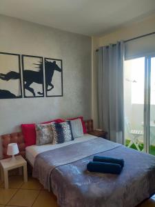 a bedroom with a bed and a large window at Entire Apartment in Agadir