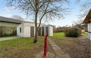 a red fire hydrant in front of a house at Three-Bedroom Holiday Home In Tranekar in Østerhuse +20 photos