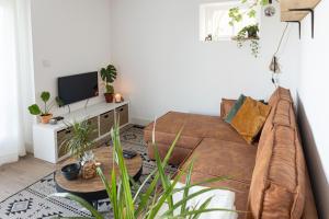 a living room with a couch and a tv at Casita in Sint Maarten