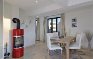 a dining room with a table and a red and white fireplace at Garden Suite in Binz