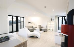 a living room with white furniture and windows at Garden Suite in Binz