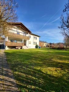 a house with a large lawn in front of it at Countryside apartment in Volkenschwand