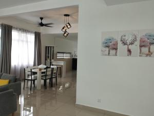 a living room and dining room with a table and chairs at Desaru coast Waterpark and Beach in Desaru +13 photos