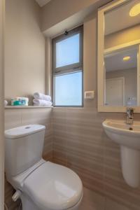 a bathroom with a toilet and a sink and a window at Ascot Bay, Premium 5BR Lagoon Beach House & Pool in Tawila, El Gouna in Hurghada