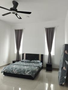 a bedroom with a bed and a ceiling fan at Desaru coast Waterpark and Beach in Desaru +14 photos