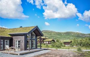 a log home with a grass roof at Nice Home In Vringsfoss With 4 Bedrooms And Wifi in Maurset