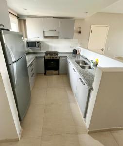 Kuchyň nebo kuchyňský kout v ubytování Dunas de las Pampas barrio de mar