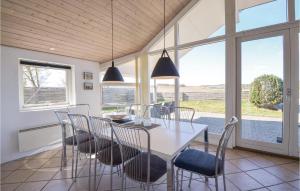 FemmøllerにあるAwesome Home In Ebeltoft With 3 Bedrooms, Sauna And Wifiのダイニングルーム(白いテーブル、椅子付)