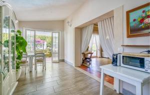 a living room with a table and a microwave at Beautiful Home In Fiumicino With Wifi in Fiumicino