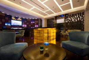 ein Restaurant mit einem Tisch und Stühlen sowie einer Bar in der Unterkunft SUNSOL UNIK Luxury Hotel in Porlamar