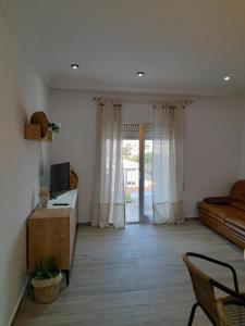 a living room with a couch and a table and a television at A vora mar in Benicarló