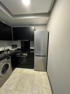 a kitchen with a refrigerator and a dishwasher at Twin Center Oasis - Luxury Apartment with Free Parking in Casablanca