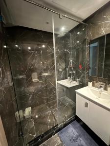 a bathroom with a shower and a sink at Twin Center Oasis - Luxury Apartment with Free Parking in Casablanca