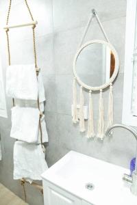 a bathroom with a towel rack and a mirror at BrideHousehaifa in Haifa