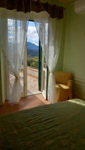 a bedroom with a bed and a window with a view at Villa Podere I Cavalieri in SantʼAnna