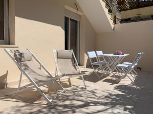 a group of chairs and a table on a patio at Suite Claudia in Sirmione