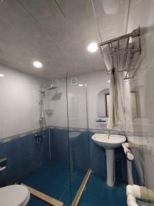a bathroom with a shower and a toilet and a sink at Qusar Qala Hotel in Qusar +143 photos