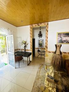 a living room with a table and a couch at Maison de 3 chambres avec piscine privee jardin clos et wifi a Sainte Rose in Sainte-Rose