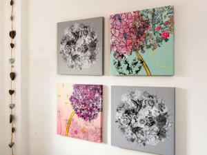 four pictures of flowers hanging on a wall at Bass Rock View in North Berwick