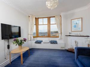a living room with a couch and a tv at Bass Rock View in North Berwick