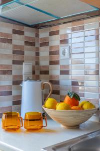 a bowl of fruit on a kitchen counter with a juicer at Anna Studio in Amoudara Herakliou