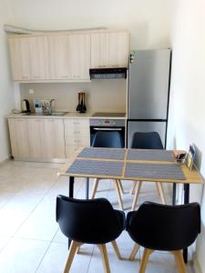 a kitchen with a table and chairs and a refrigerator at Maza House in Stavros