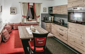 une cuisine avec une table en bois et un canapé dans l'établissement 1 Bedroom Lovely Apartment In Unterweg, 