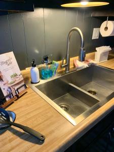 a kitchen counter with a stainless steel sink at Maison Solange-Red Barn Farmhouse Style- Moonridge in Big Bear Lake