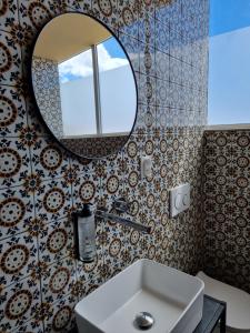 a bathroom with a sink and a mirror at Rooftop Guesthouse Alvor in Alvor