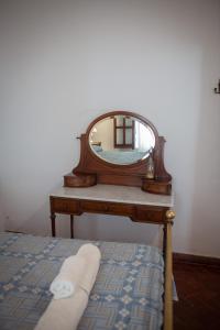 a bedroom with a bed and a mirror on a table at Tampu in Cachí