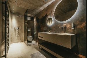a bathroom with a sink and a toilet at The Black Eagle Luxury Appartements in Mayrhofen