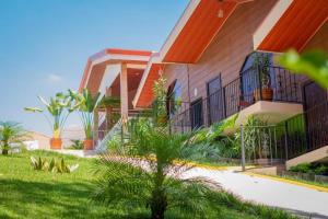 a house with a yard with grass and plants at Hotel Boutique Meraki in Caldera