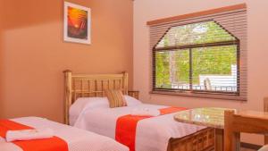 a bedroom with two beds and a window at Hotel Boutique Meraki in Caldera +10 photos