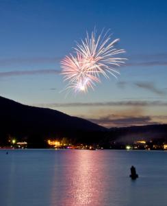 a firework in the sky over a body of water at Depe Dene Lakeside Resort in Lake George
