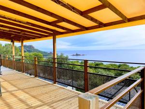 a balcony with a view of a ship in the distance at Blue Horizon in Saint-Raphaël