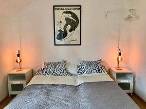 a bedroom with a bed with two night stands at Kiscsillag Vendégház in Budapest
