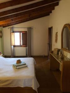 a bedroom with a bed and a dresser and a mirror at Lovely Appartment 'Solana' with big garden, nice pool in Teulada